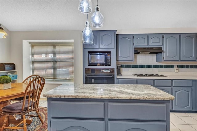 kitchen with hanging light fixtures, blue cabinetry, decorative backsplash, and black appliances