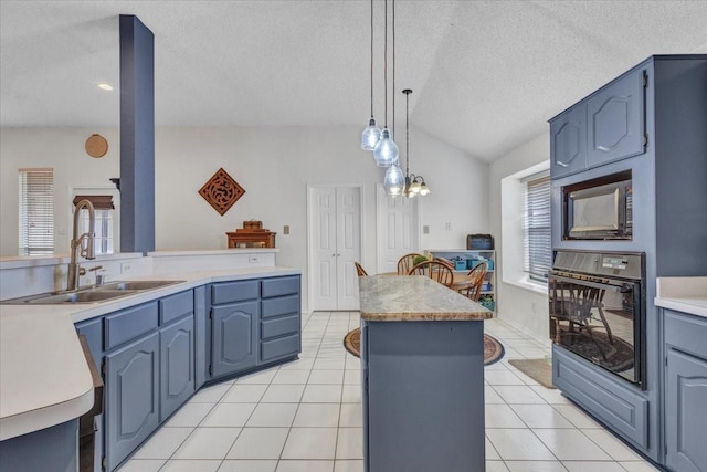 kitchen featuring a kitchen island, sink, hanging light fixtures, light tile patterned floors, and black appliances