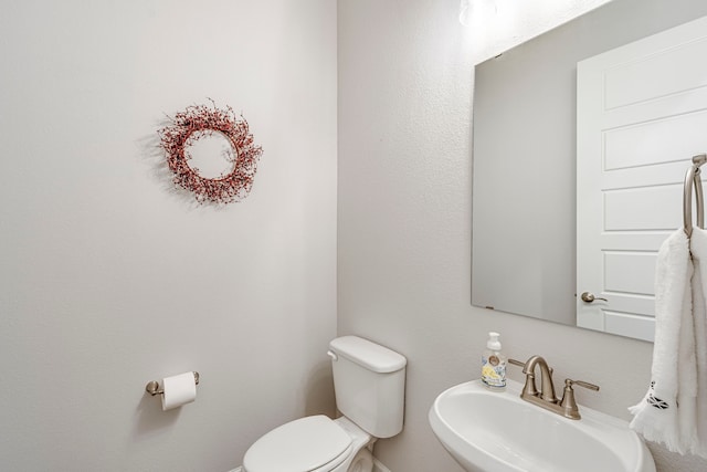 bathroom with toilet and sink