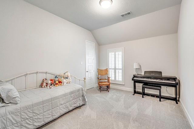 bedroom with lofted ceiling and light carpet