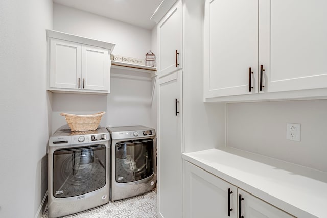 washroom featuring washing machine and dryer and cabinets