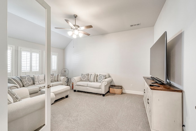 carpeted living room with vaulted ceiling and ceiling fan