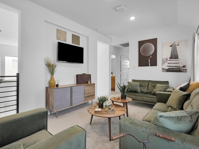 carpeted living area featuring visible vents and recessed lighting