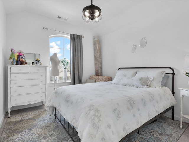 bedroom featuring visible vents and vaulted ceiling