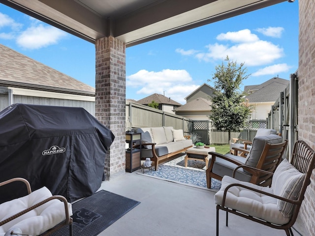 view of patio featuring outdoor lounge area, a fenced backyard, and a grill