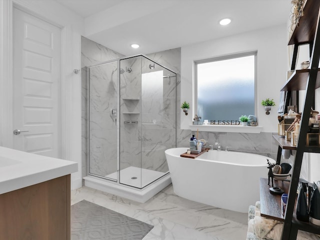 full bath featuring a soaking tub, recessed lighting, marble finish floor, and a marble finish shower