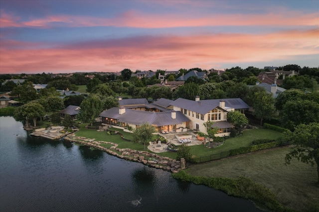 aerial view at dusk with a water view