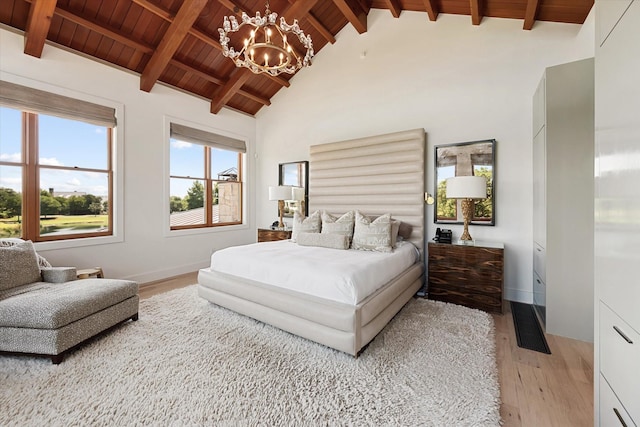 bedroom featuring an inviting chandelier, wood ceiling, high vaulted ceiling, beam ceiling, and light hardwood / wood-style floors