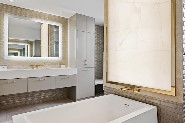 bathroom featuring a washtub and vanity