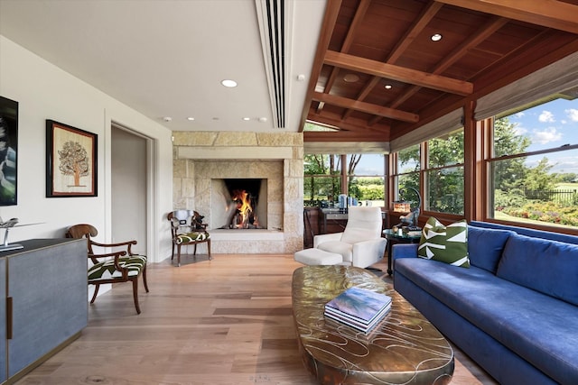 sunroom / solarium featuring a high end fireplace, lofted ceiling with beams, and wooden ceiling