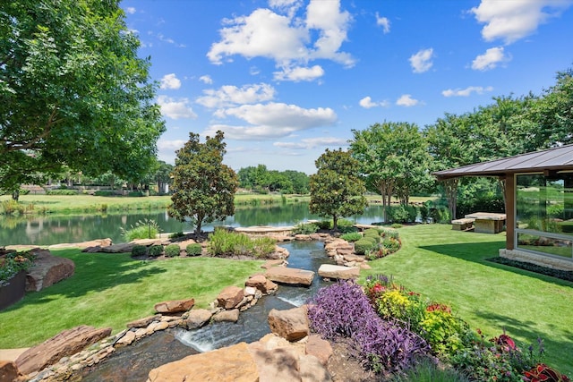 view of yard featuring a gazebo and a water view