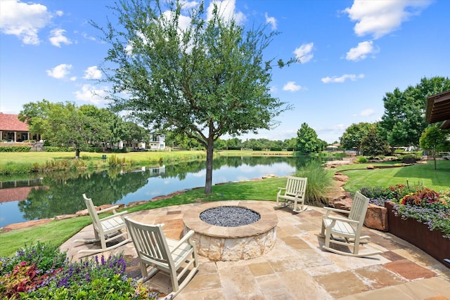 view of patio with a water view and an outdoor fire pit