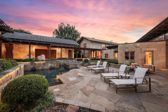 patio terrace at dusk featuring an outdoor hangout area