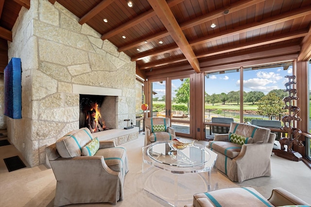 living room with lofted ceiling with beams, a stone fireplace, and wood ceiling