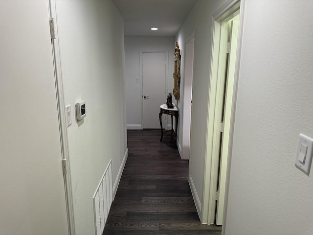 corridor featuring dark hardwood / wood-style floors