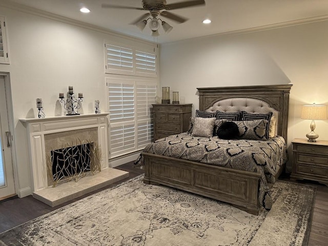 bedroom with ornamental molding, dark hardwood / wood-style floors, and ceiling fan