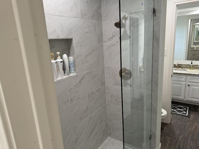 bathroom with vanity, an enclosed shower, and toilet