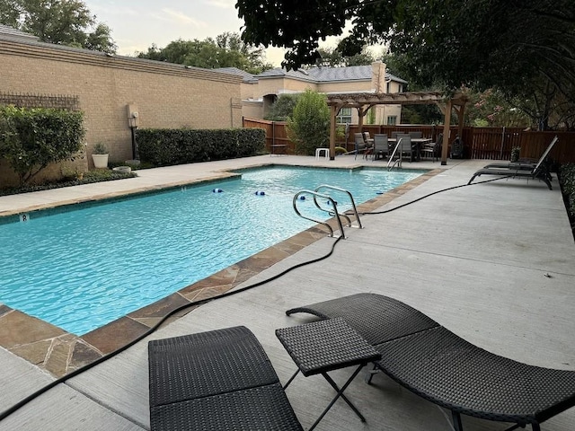 view of pool with a pergola and a patio