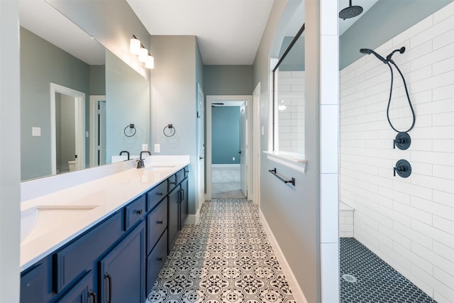 bathroom with vanity, a tile shower, tile patterned floors, and toilet