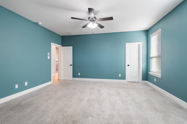 carpeted empty room featuring ceiling fan