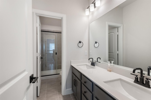 bathroom with an enclosed shower, vanity, tile patterned flooring, and toilet