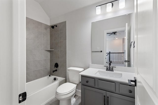 full bathroom featuring vanity, tiled shower / bath combo, vaulted ceiling, and toilet