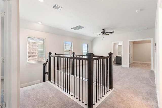 hall featuring light colored carpet