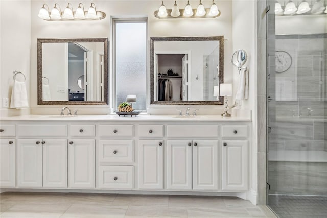 bathroom with vanity and a shower with door