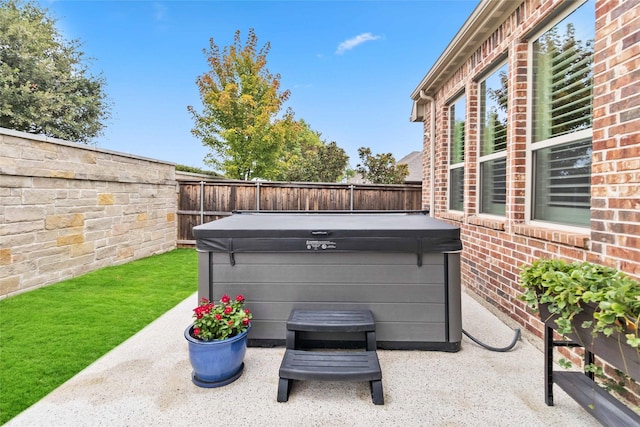 view of patio / terrace with a hot tub