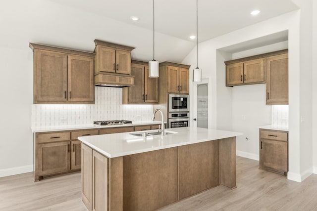 3350 Blazing Star Dr, Crandall, TX 75114 - kitchen with appliances with stainless steel finishes, a sink, light wood finished floors, baseboards, and backsplash