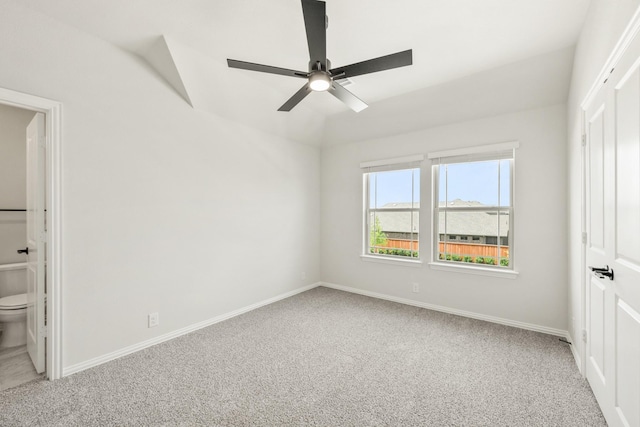 3350 Blazing Star Dr, Crandall, TX 75114 - unfurnished bedroom with light carpet, baseboards, ceiling fan, ensuite bathroom, and vaulted ceiling