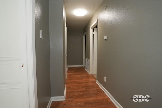 hallway with dark wood-type flooring