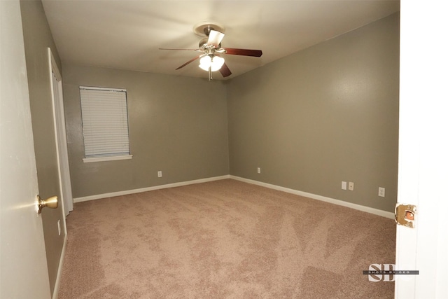 spare room featuring ceiling fan and light carpet