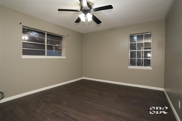 empty room with dark hardwood / wood-style floors and ceiling fan