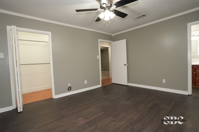 unfurnished bedroom featuring dark hardwood / wood-style flooring, ornamental molding, ceiling fan, and ensuite bathroom