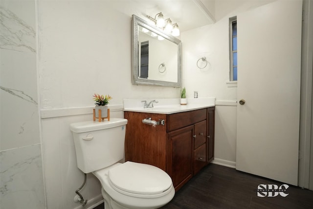 bathroom with vanity, wood-type flooring, and toilet