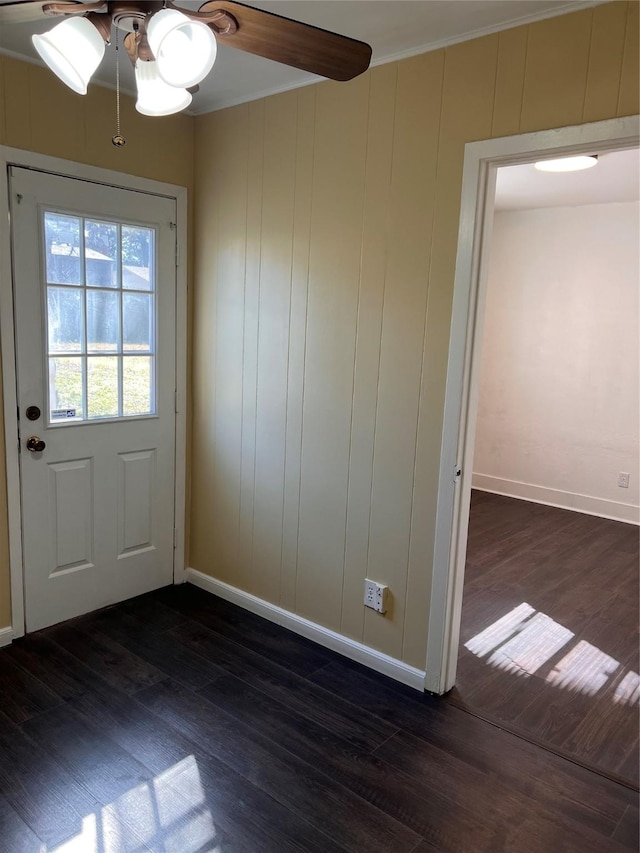 doorway to outside featuring crown molding, ceiling fan, and dark hardwood / wood-style flooring