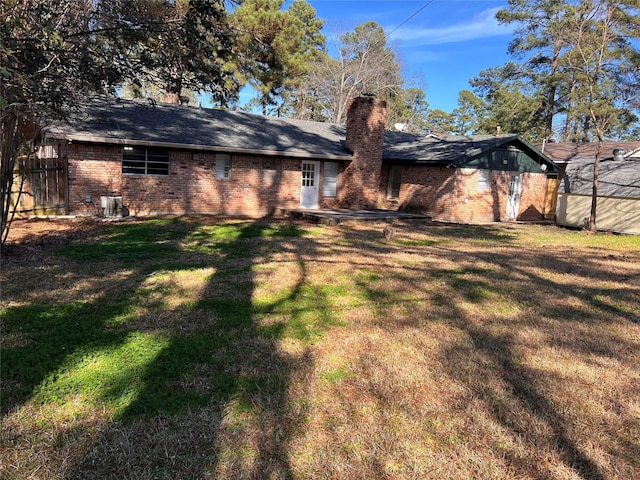 back of property featuring a lawn