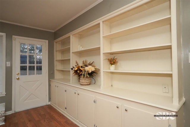 doorway to outside with ornamental molding and dark wood-type flooring