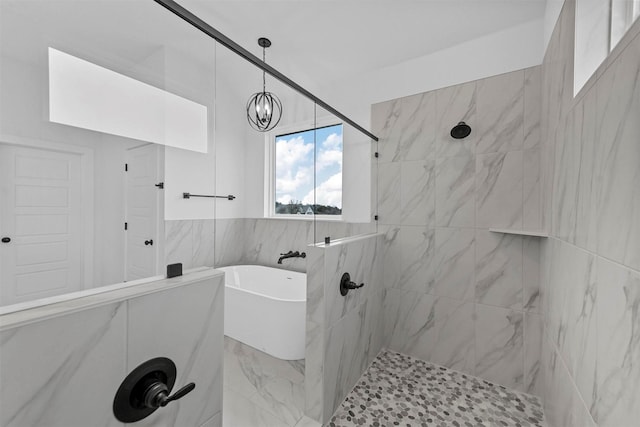 bathroom featuring separate shower and tub and a notable chandelier