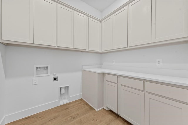 washroom featuring cabinets, washer hookup, hookup for an electric dryer, and light hardwood / wood-style floors