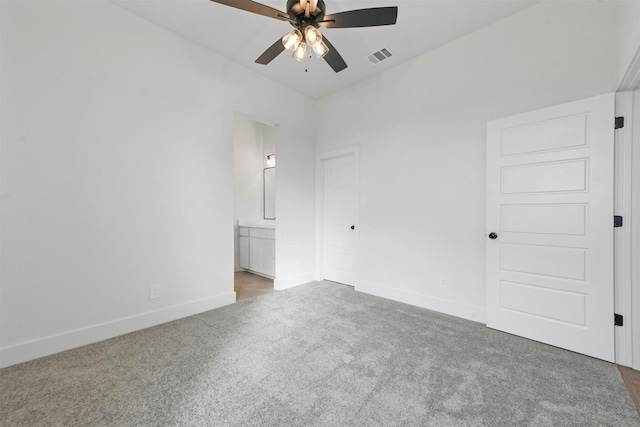 unfurnished bedroom featuring ensuite bath, ceiling fan, and carpet flooring