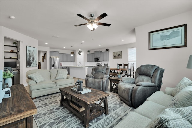 living room with sink and ceiling fan