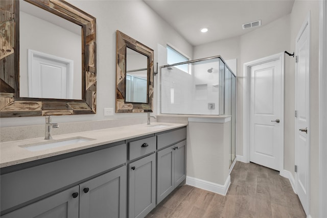 bathroom featuring vanity, a shower with door, and hardwood / wood-style floors