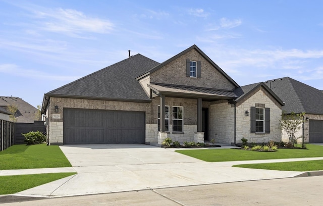 view of front of house with a garage and a front lawn