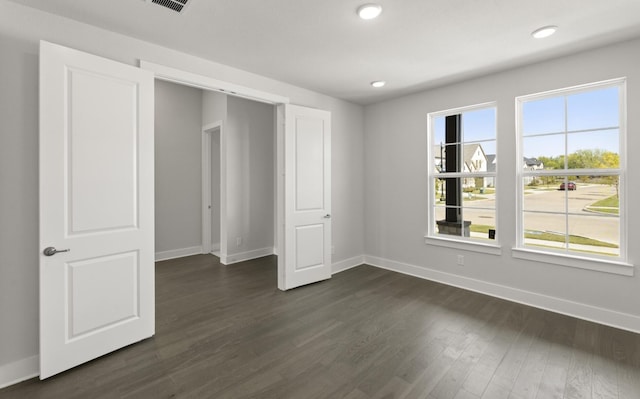 unfurnished bedroom featuring dark hardwood / wood-style flooring