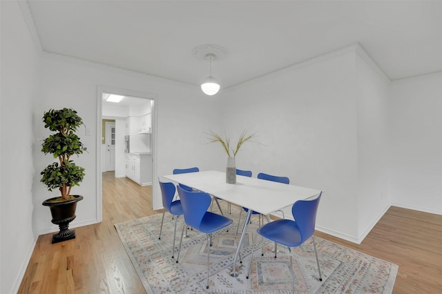 dining space with light hardwood / wood-style flooring