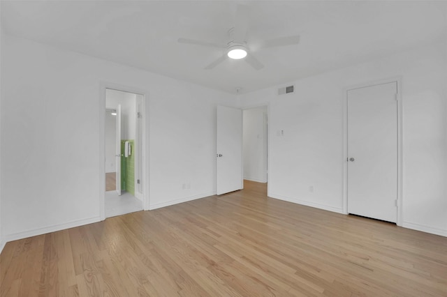 unfurnished bedroom with ceiling fan, connected bathroom, and light hardwood / wood-style floors