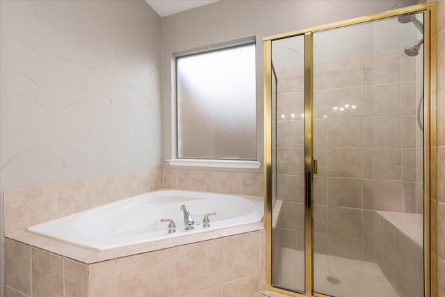 bathroom featuring a healthy amount of sunlight, a shower stall, and a bath