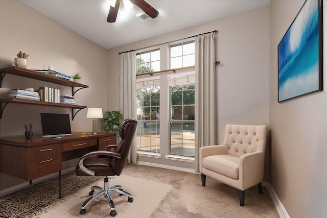 carpeted office featuring ceiling fan, vaulted ceiling, visible vents, and baseboards